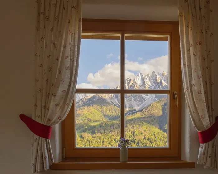 Framed Print : View through a window to the Dolomites in the foreground a small vase with meadow flowers on the windowsill Framed Print : View through a window to the Dolomites in the foreground a small vase with meadow flowers on the windowsill