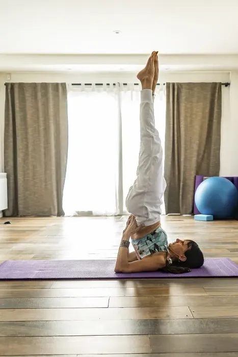 Framed Print : Side view of a woman practicing yoga Framed Print : Side view of a woman practicing yoga