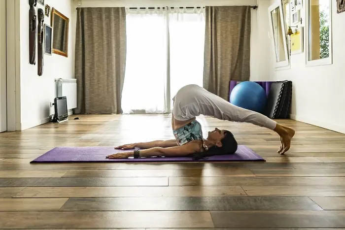 Framed Print : Side view of a woman practicing yoga Framed Print : Side view of a woman practicing yoga