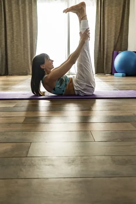 Framed Print : Side view of a woman practicing yoga Framed Print : Side view of a woman practicing yoga
