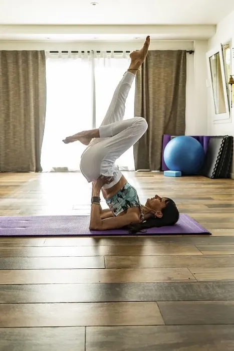 Framed Print : Side view of a woman practicing yoga on a mat Framed Print : Side view of a woman practicing yoga on a mat
