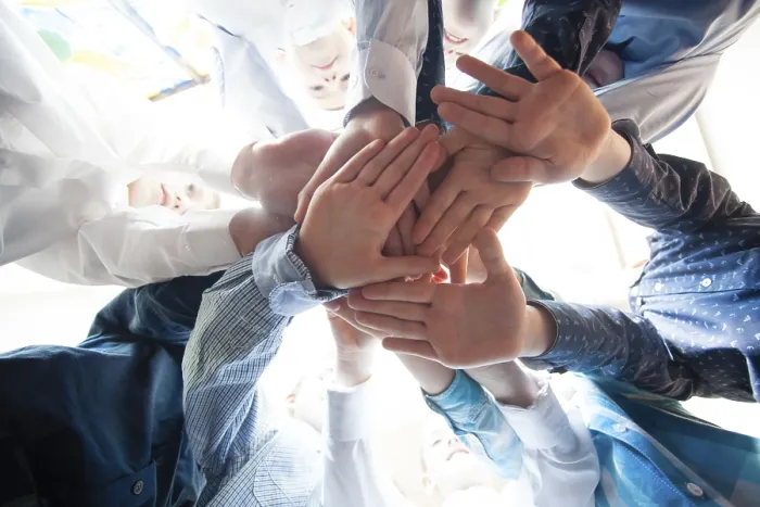 Framed Print : Bottom view of young boys putting their hands together as a symbol of friendship Framed Print : Bottom view of young boys putting their hands together as a symbol of friendship