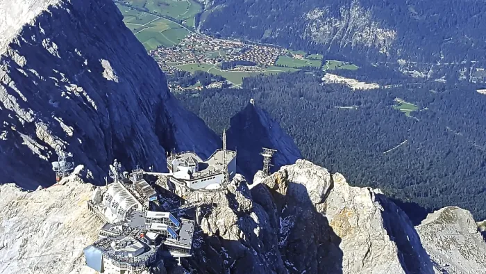 Framed Print : View from above of Zugspitze with a village and green fields in the background