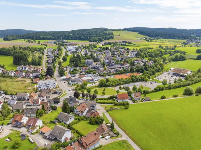 Framed Print : Village in a hilly, rural setting with scattered houses and green fields Framed Print : Village in a hilly, rural setting with scattered houses and green fields