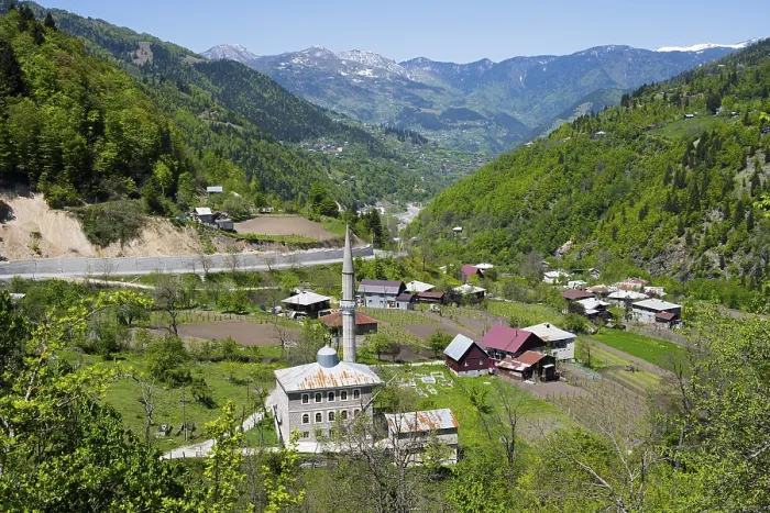 Framed Print : Village with a mosque in a green valley surrounded by mountains