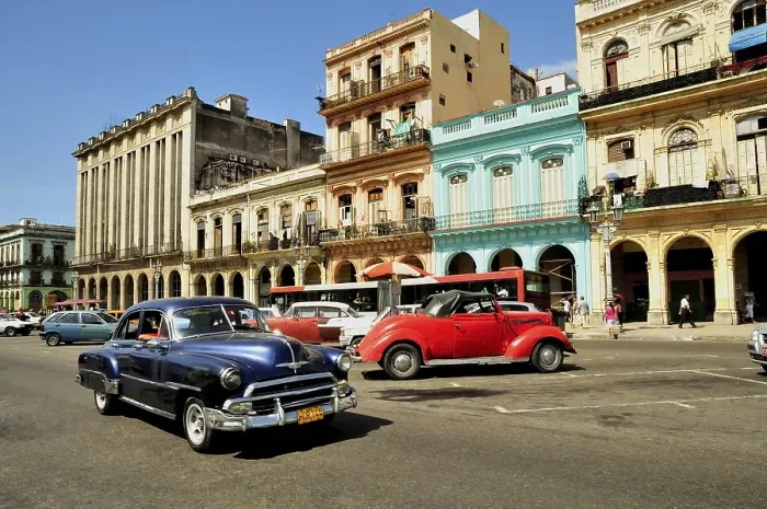 Framed Print : Vintage car in front of buildings with colourful facades Framed Print : Vintage car in front of buildings with colourful facades