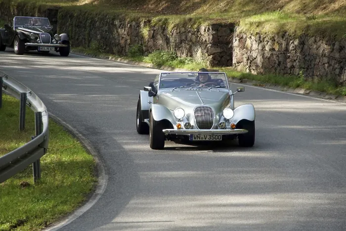 Framed Print : Vintage car convoy on a winding road next to a stone wall Framed Print : Vintage car convoy on a winding road next to a stone wall