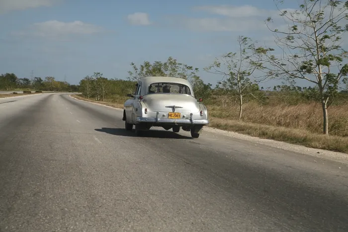 Framed Print : Vintage car driving along the autopista from Vinales to Havana
