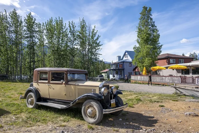 Framed Print : Vintage car and historic building