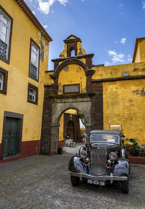 Framed Print : Vintage car parked in front of yellow gate and wall Framed Print : Vintage car parked in front of yellow gate and wall