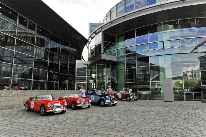 Framed Print : Vintage cars parked in a square in front of modern glass buildings