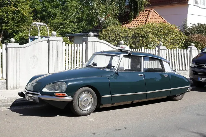 Framed Print : Vintage Citroen DS parked on the street in front of a garden fence Framed Print : Vintage Citroen DS parked on the street in front of a garden fence