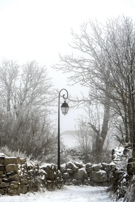Framed Print : A vintage lamp post stands still amidst a snowy landscape