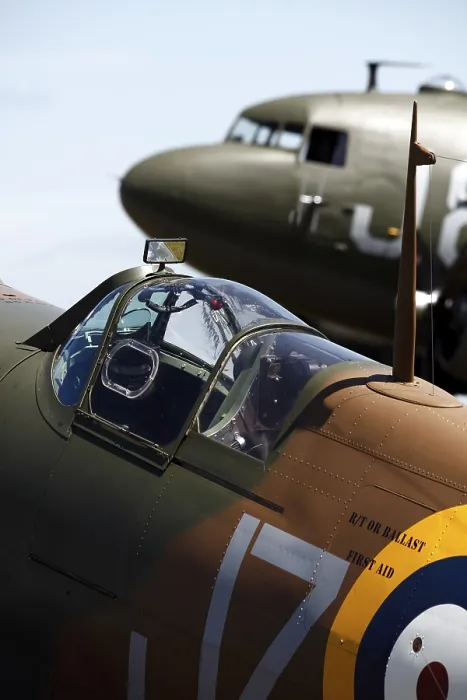 Framed Print : A vintage Spitfire fighter plane pictured in front of a DC-3 transport aircraft from World War Two at the Cotswold