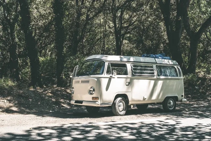 Framed Print : Vintage white bus camper on the road