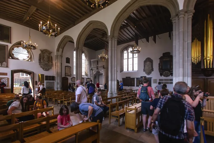 Framed Print : Visitors inside a church with arches