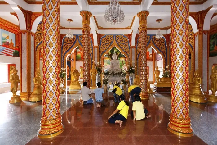 Framed Print : Visitors praying in front of the altar