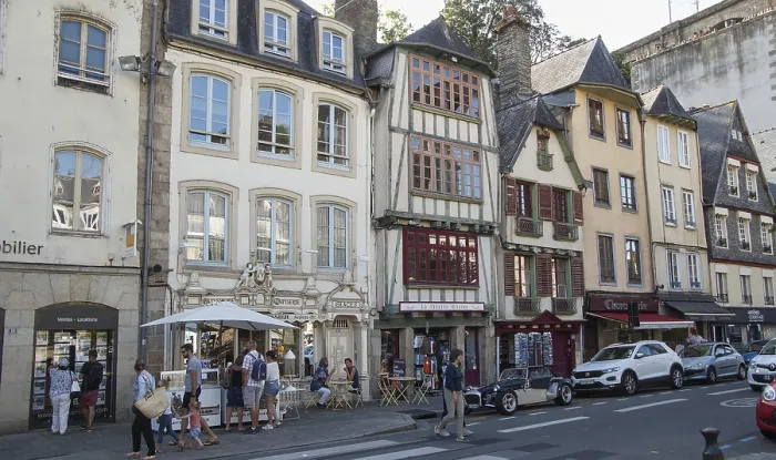 Framed Print : Vivid street scene with people sitting in cafes surrounded by traditional buildings