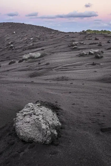 Framed Print : Volcanic bombs, lava rock on the edge of the crater of Mount Yasur volcano in the morning light
