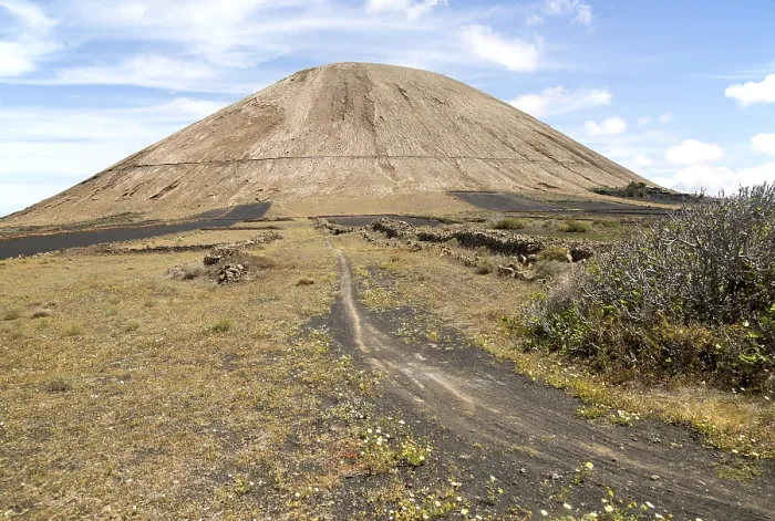 Framed Print : Volcano cone and black volcanic soil farmland