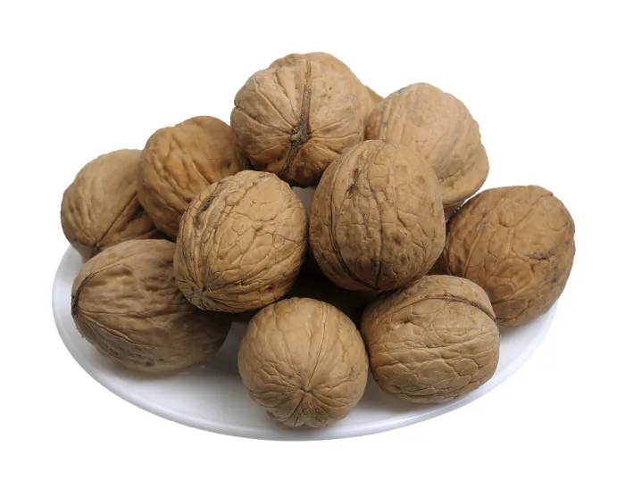 Framed Print : Walnuts in a white plate on a white background