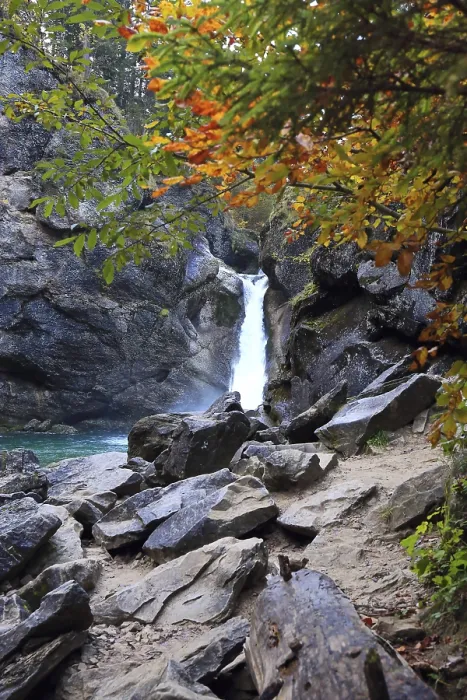 Framed Print : Waterfall surrounded by rocks and autumn trees