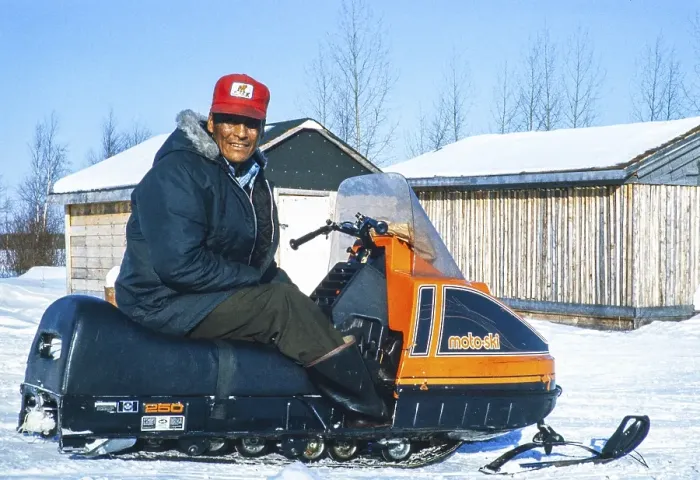 Framed Print : Webequie First Nation Ojibway community, Eastwood Island, Northern Ontario, Canada 1978 Man sitting on moto ski snowmobile