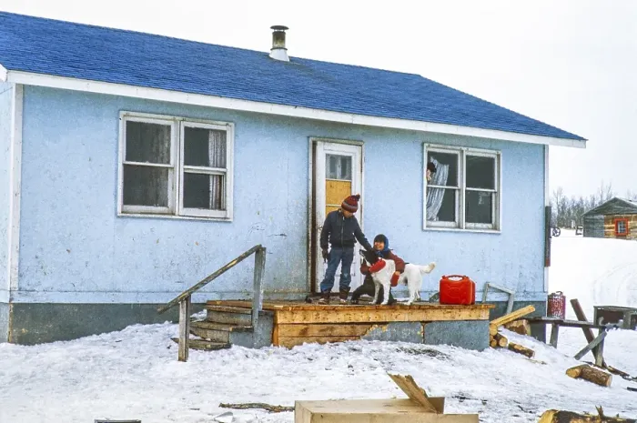 Framed Print : Webequie First Nation Ojibway community, Eastwood Island, Northern Ontario, Canada 1978 Children petting their dog in front of the house Framed Print : Webequie First Nation Ojibway community, Eastwood Island, Northern Ontario, Canada 1978 Children petting their dog in front of the house