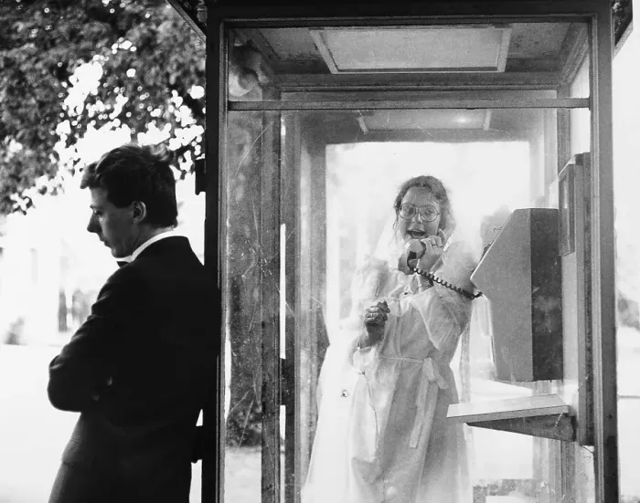 Framed Print : Wedding ouple in a public telephone booth