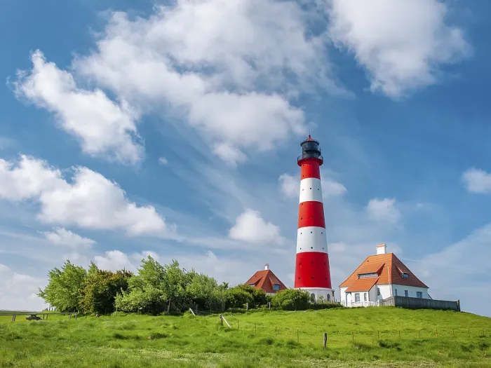 Framed Print : The Westerheversand lighthouse under a blue sky with white clouds
