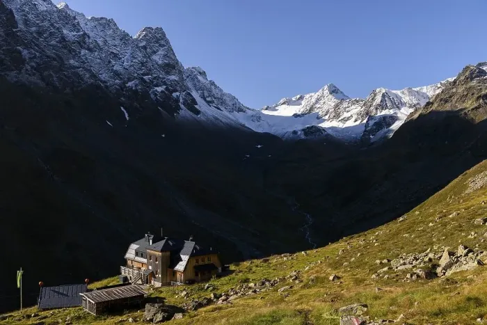 Framed Print : Westfalenhaus in front of on mountain meadow in front of snowy peaks of the Sellrain mountains
