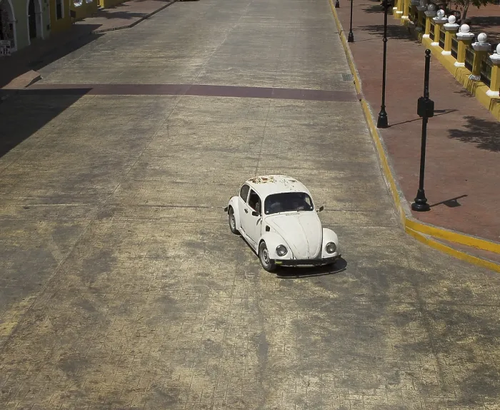 Framed Print : White beetle car driving on the main street of a mexican village Framed Print : White beetle car driving on the main street of a mexican village