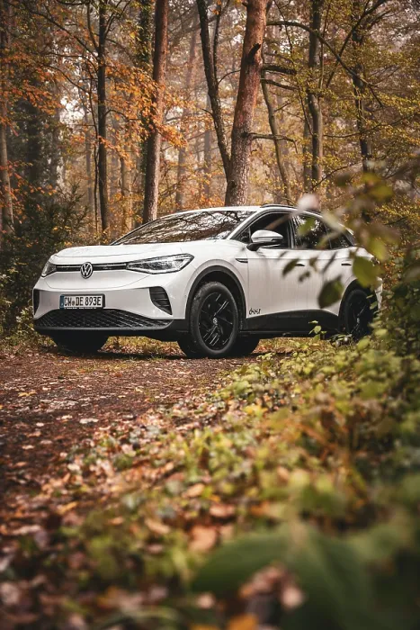 Framed Print : White car in autumn forest on a dirt road