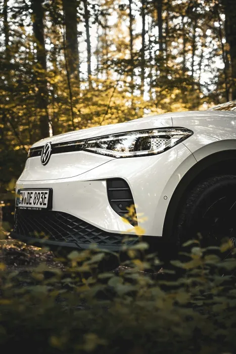 Framed Print : White car in the forest with golden sunlight through the trees