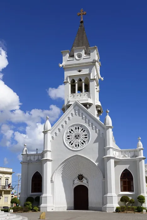 Framed Print : White church with bell tower and Gothic architecture under a clear blue sky