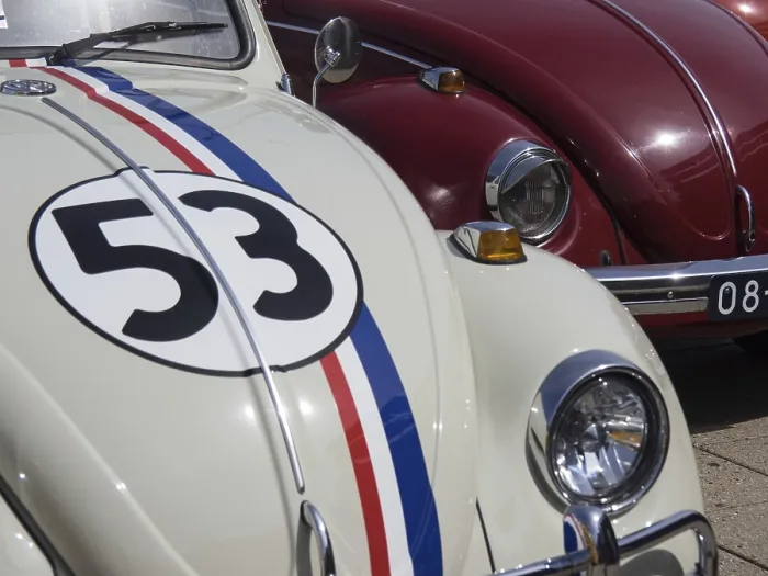 Framed Print : White classic car with racing stripes and number next to a red vehicle