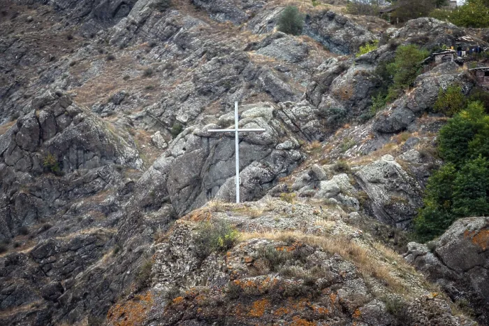 Framed Print : White commemorative cross on the top of the hill against the background of the mountain landscape Framed Print : White commemorative cross on the top of the hill against the background of the mountain landscape