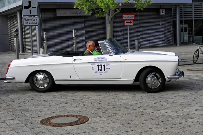 Framed Print : White convertible with an elderly man driving at a classic car event