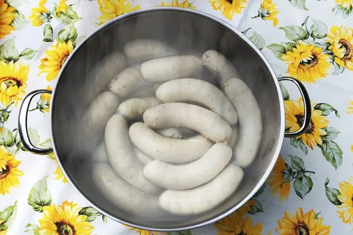 Framed Print : White sausages in a pot of hot water