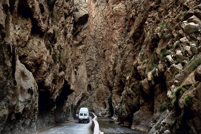 Framed Print : A white vehicle drives through the narrow section of Dades Gorge Framed Print : A white vehicle drives through the narrow section of Dades Gorge