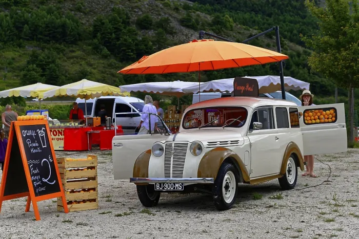 Framed Print : A white vintage car at a market