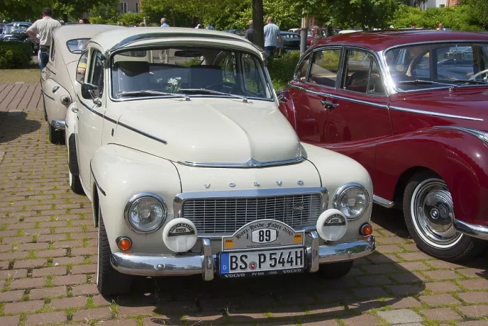 Framed Print : A white Volvo classic car stands in the sun