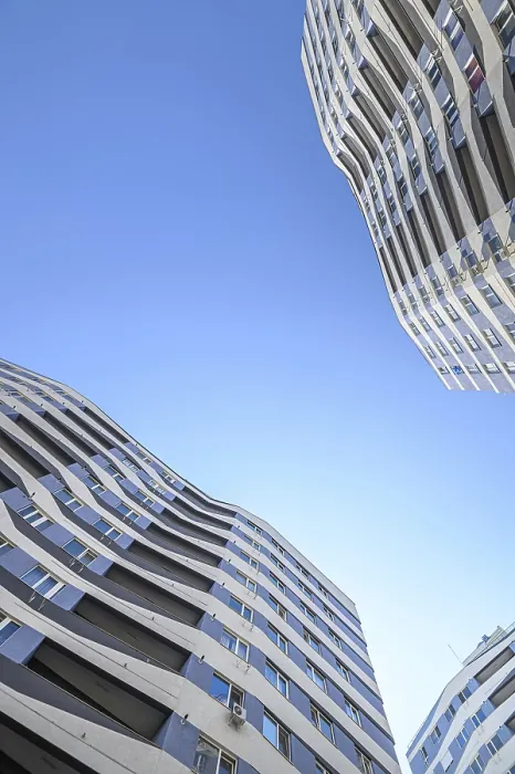 Framed Print : Wide angle shot of new apartments buildings exterior at the background of clear blue sky