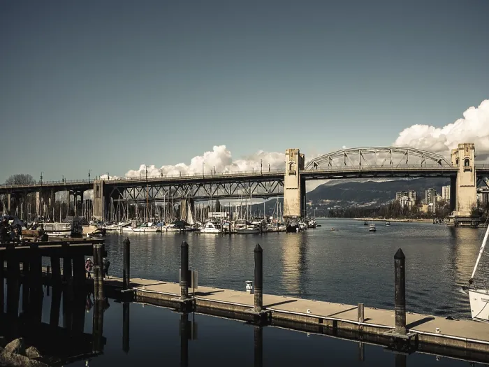 Framed Print : A wide bridge spans over a marina filled with boats