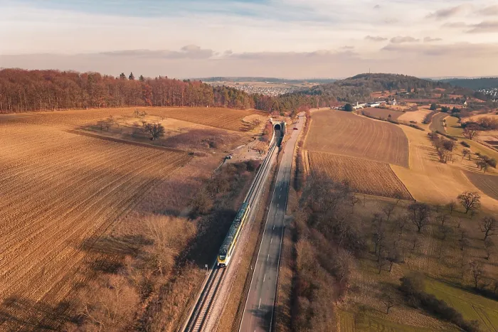 Framed Print : Wide landscape with railroad tracks and a distant train