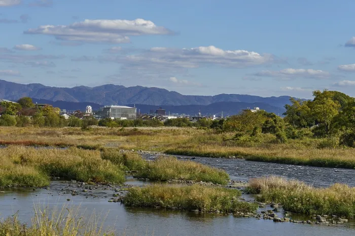 Framed Print : Wide river landscape with mountains in the background and clear blue sky
