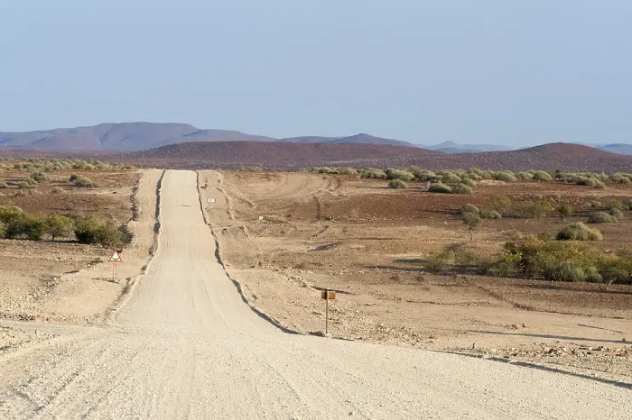 Framed Print : Wide, straight gravel road in dry landscape