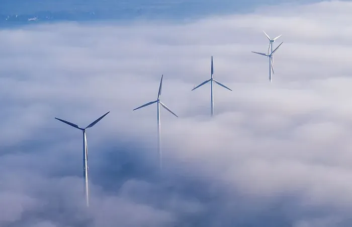 Framed Print : Wind power station in the fog, aerial view