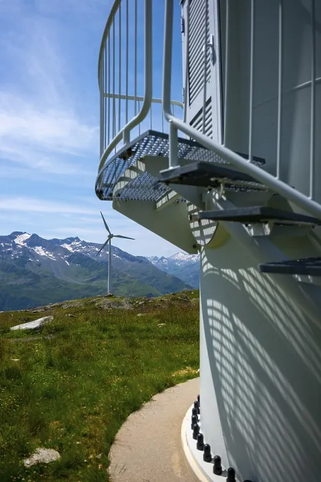 Framed Print : Wind Turbine and Column and Mountain with Glacier in the Swiss Alps and Against Blue Sky