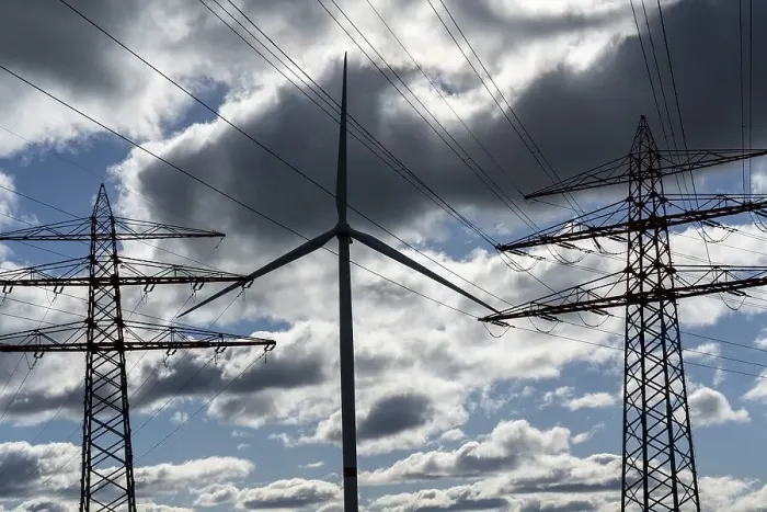 Framed Print : Wind turbine, high-voltage pylons